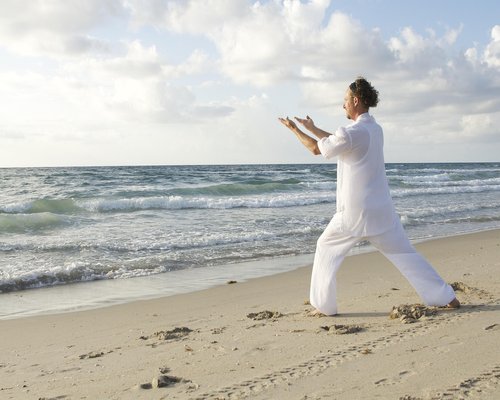 Woman practicing yoga outdoors in sunlight